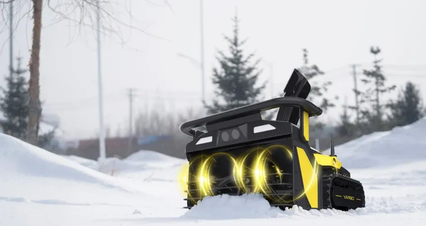 The Yarbo robot in falling snow with its twin augers glowing as they spin